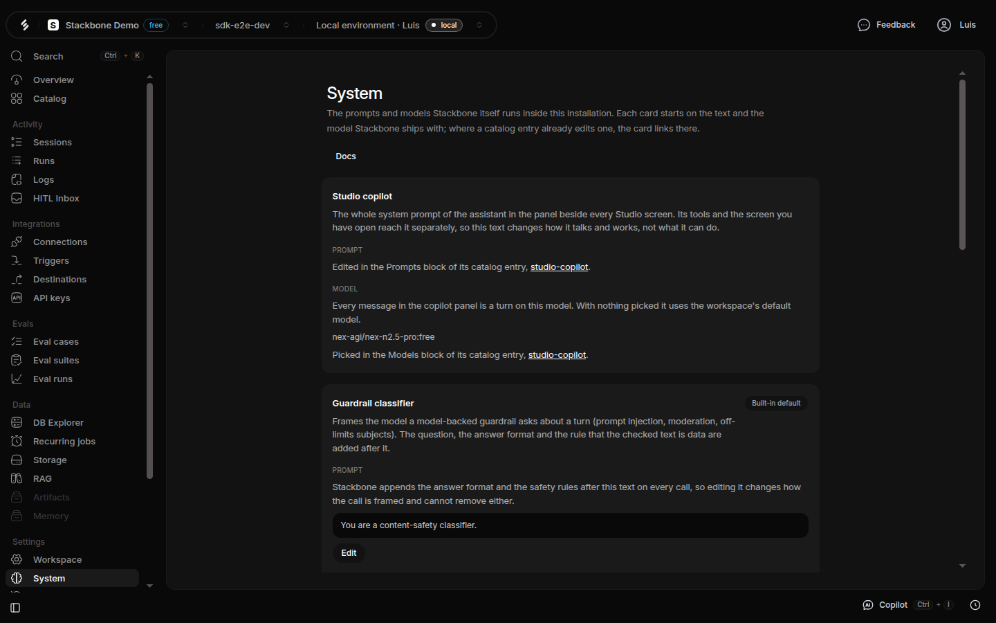 The Model defaults screen in Studio: a Studio copilot card that links to its catalog entry for the prompt and the model and names the model it runs on, above a Guardrail classifier card marked Built-in default, showing its prompt text and an Edit button.